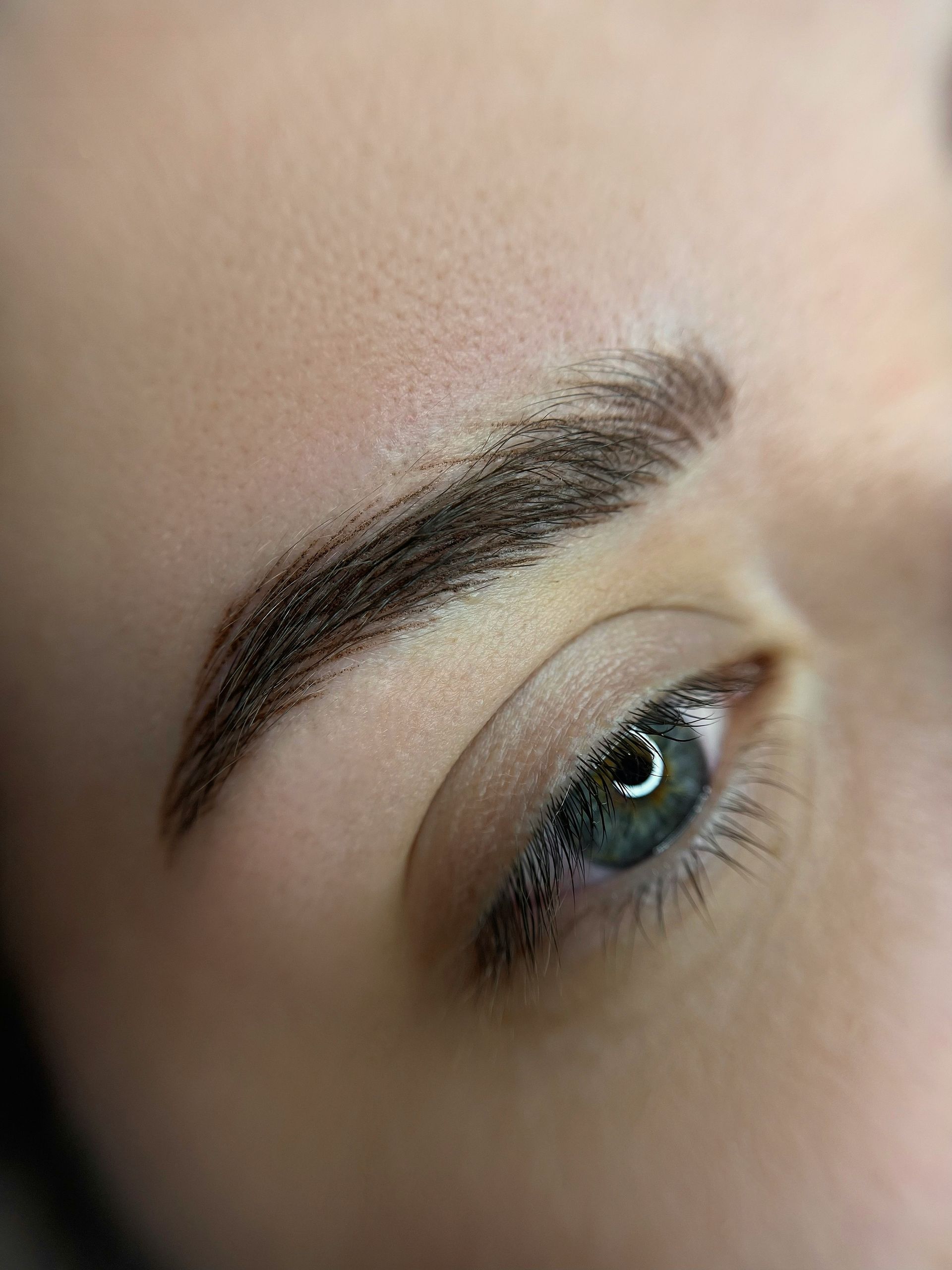 a close up of a person's eye with a pair of scissors